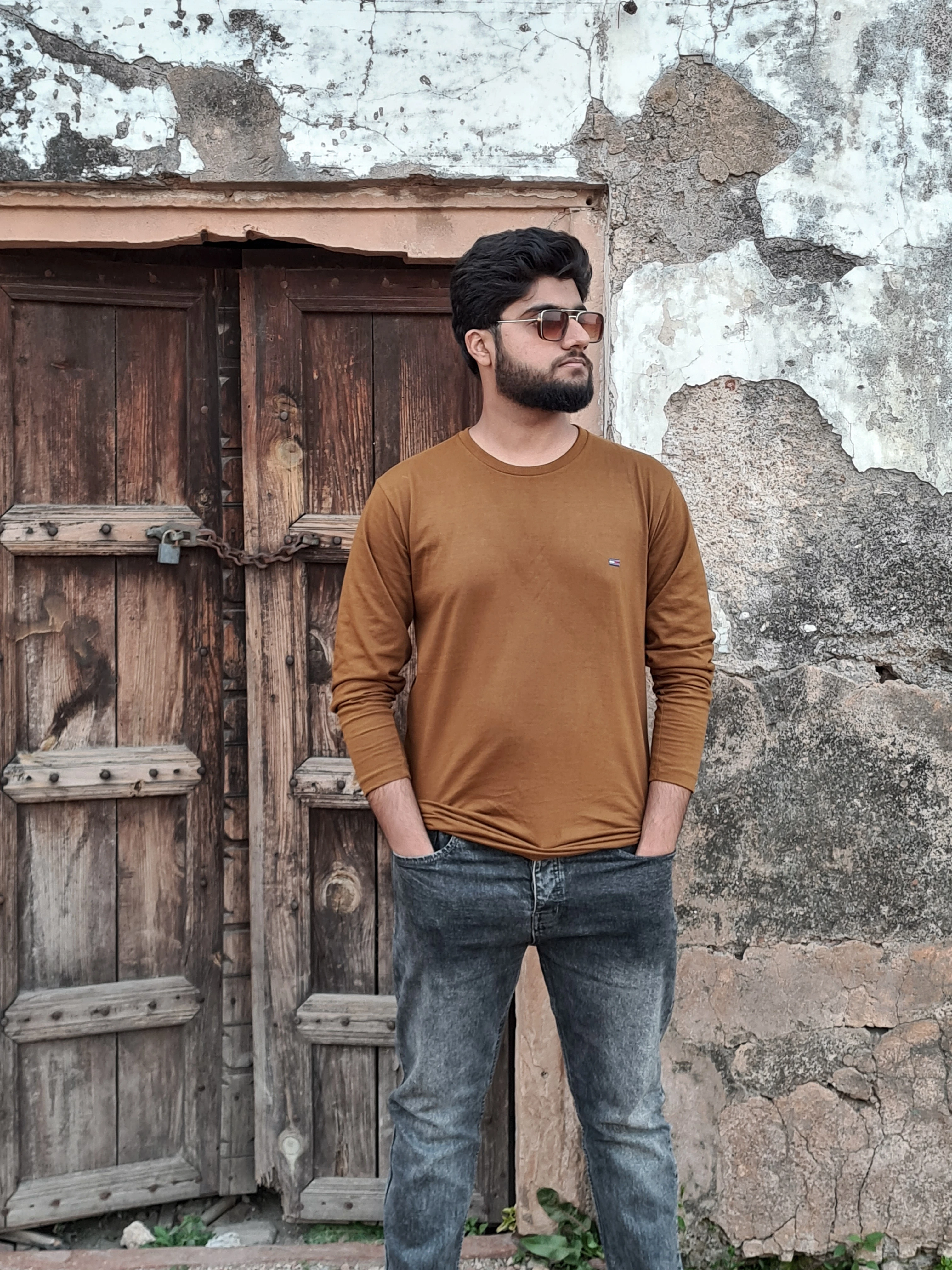 ProDeSquare posing with sunglasses before an ancient wall